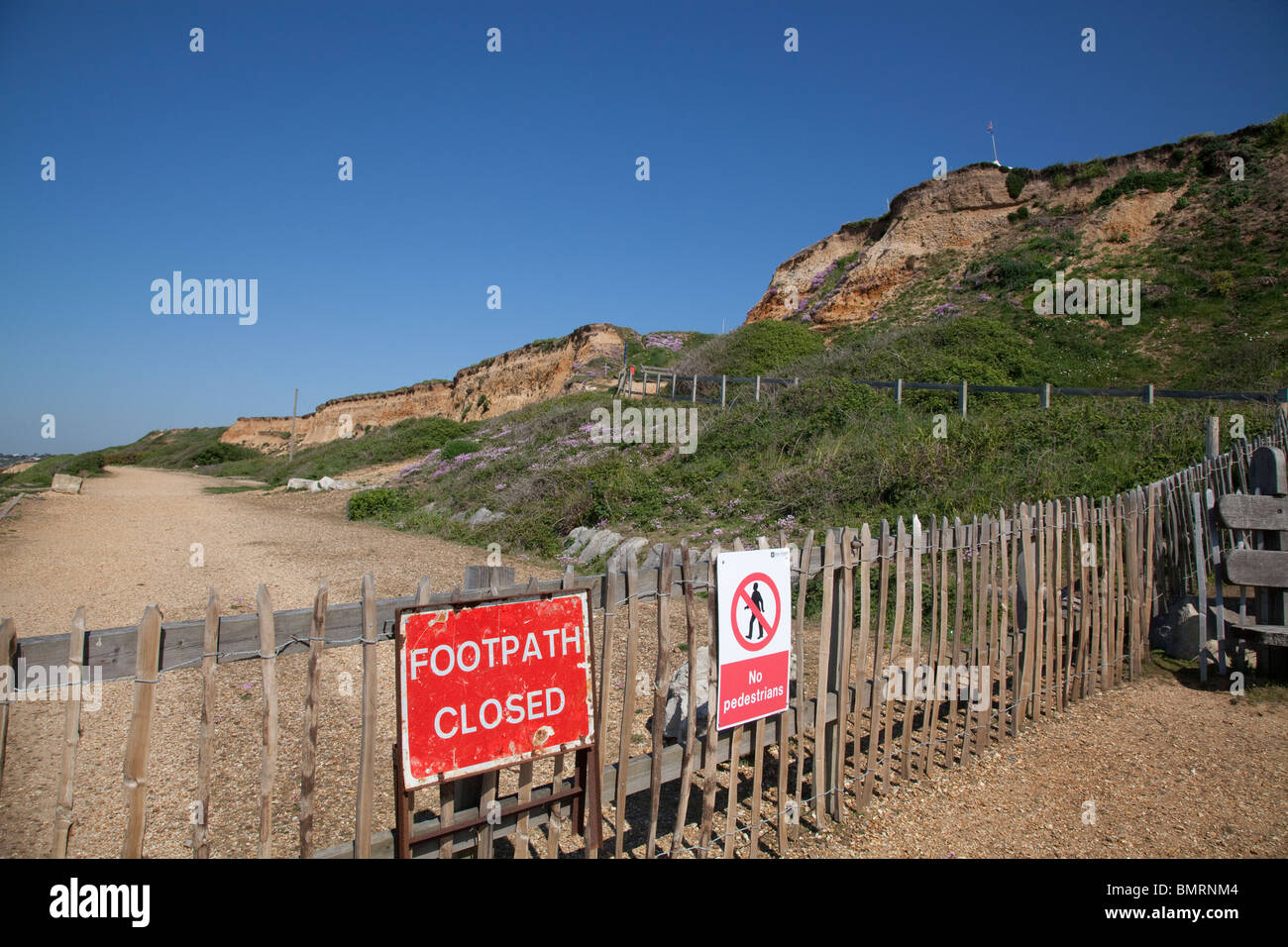 under cliff path closed sign and fencing due to ground movement erosion at Barton on Sea Stock Photo