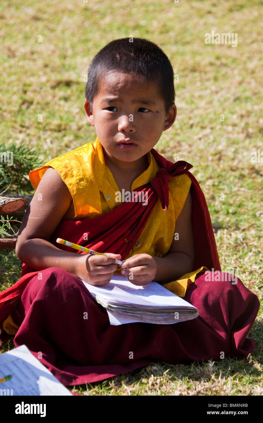 Young novice monk studying in a monastery near Punakha Bhutan Stock Photo