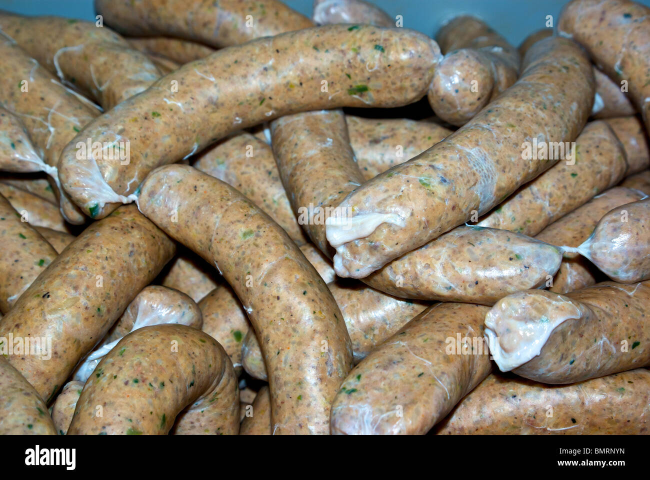 Plastic tub of spicy boudin blanc sausage made with pork green onions spices rice hot peppers liver Stock Photo