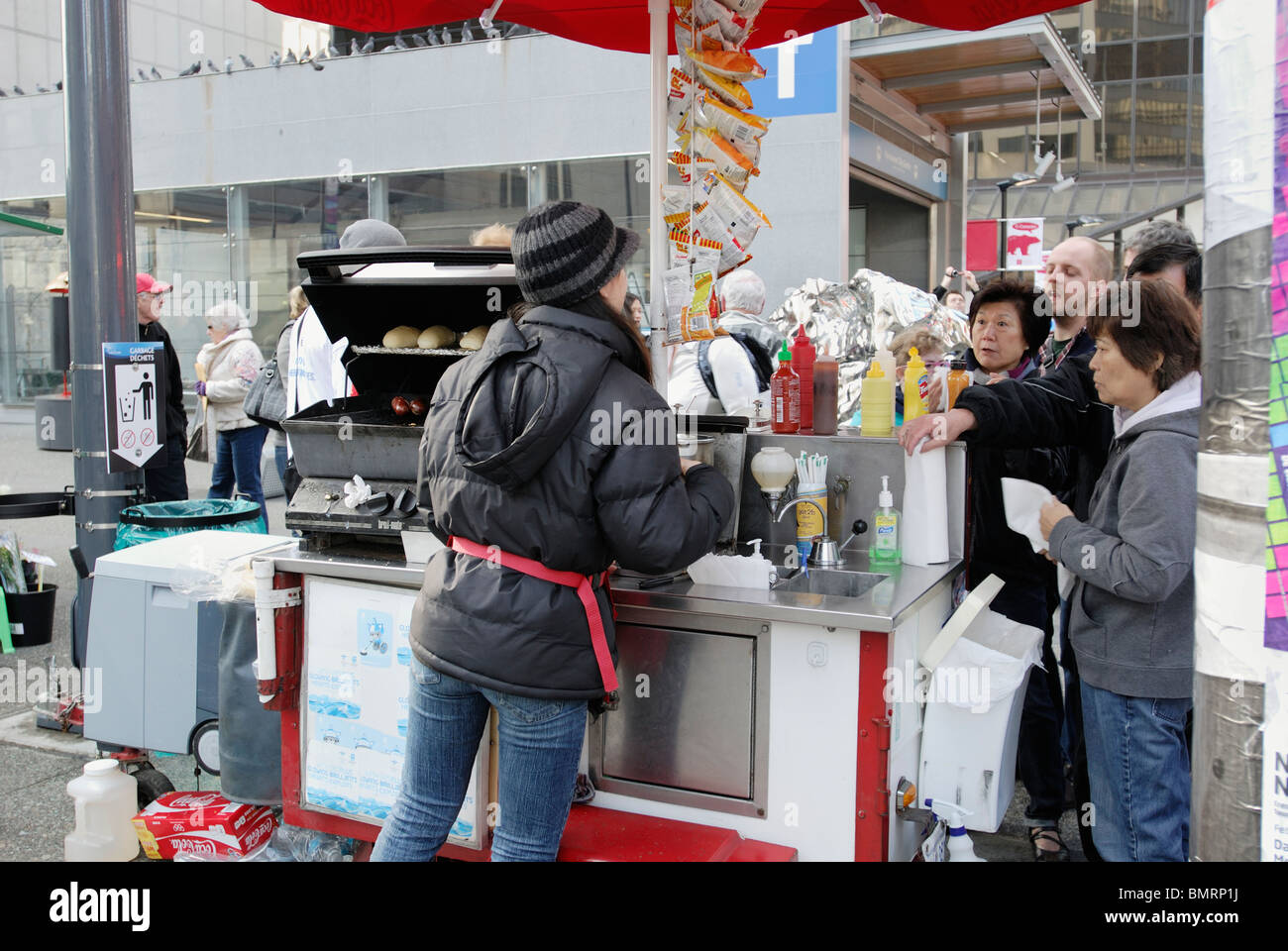 Street vendor selling street food to her customers on the streets of