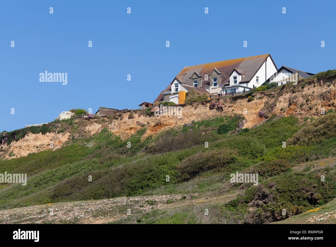 buildings on the cliff edge at Barton on Sea in Hampshire in danger of falling into the sea due to costal erosion Stock Photo
