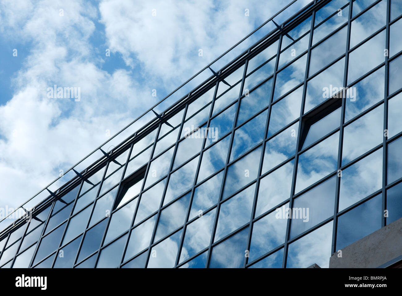Modern office building with cloud reflections on the glass Stock Photo ...