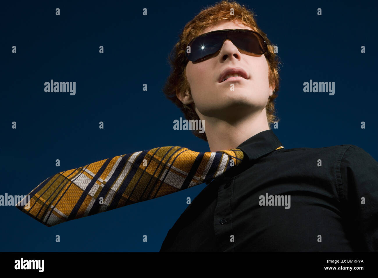 A Young Man Wearing Sunglasses And A Necktie Stock Photo