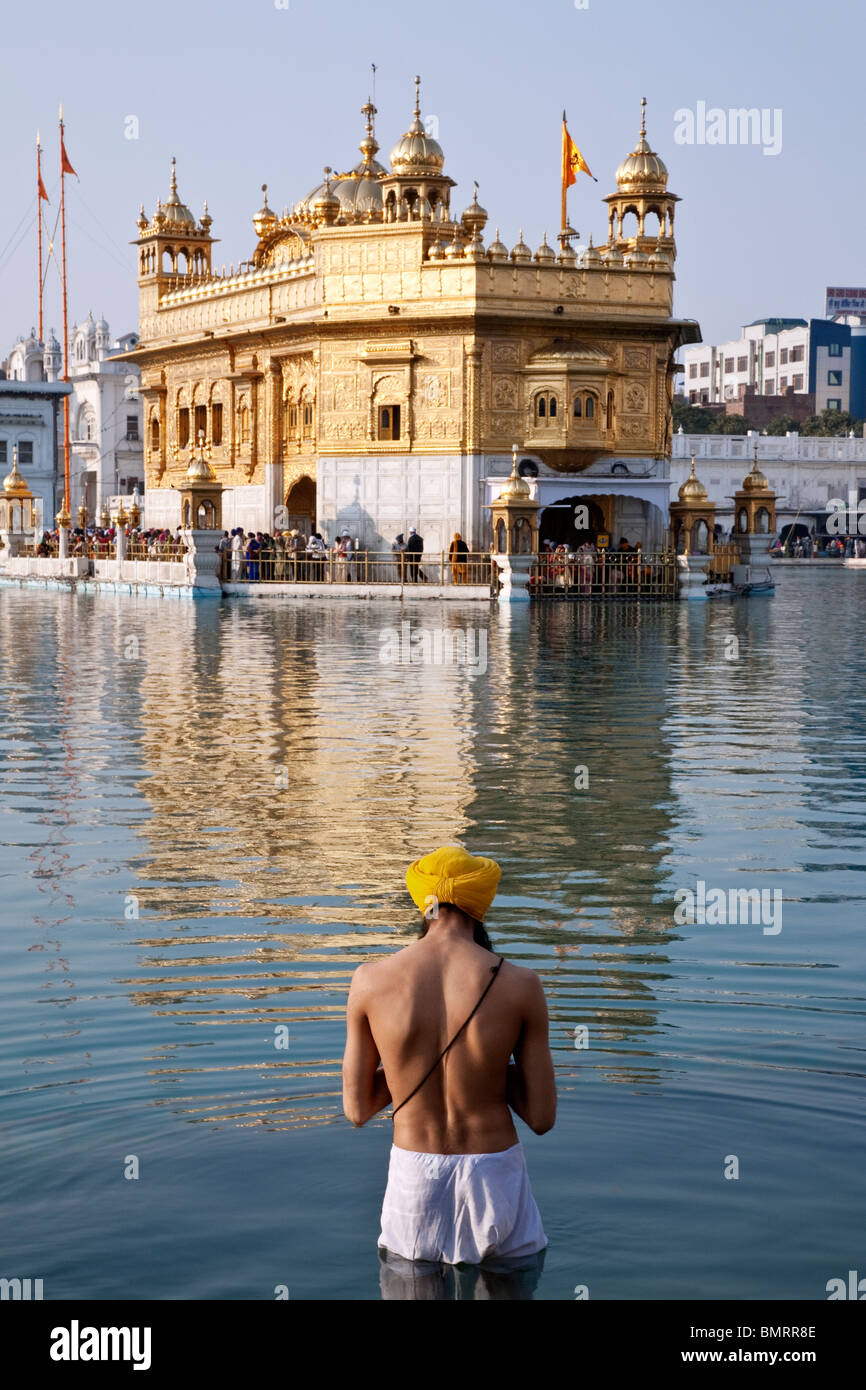Sikh man bathing in the sacred pool. The Golden Temple. Amritsar. Punjab. India Stock Photo