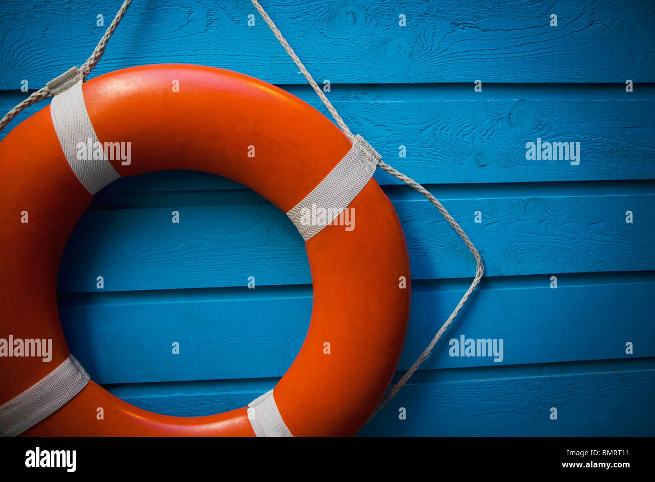A Life Preserver Hanging On A Blue Wall Stock Photo