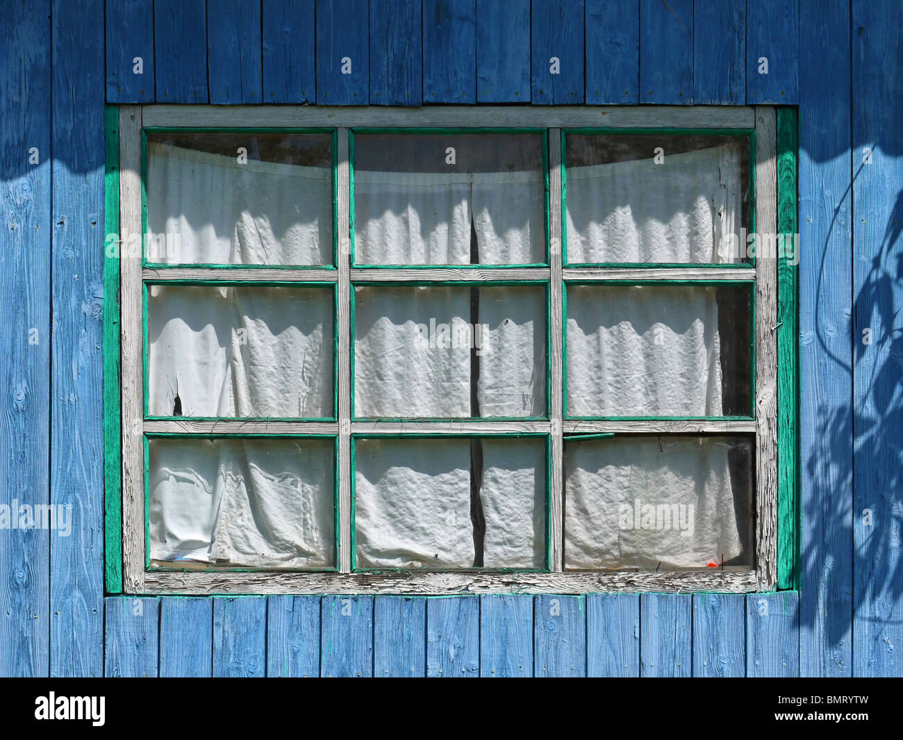 Window of summer extension to the blue wooden country house in Izhevsk region, Udmurt Republic, Russia Stock Photo