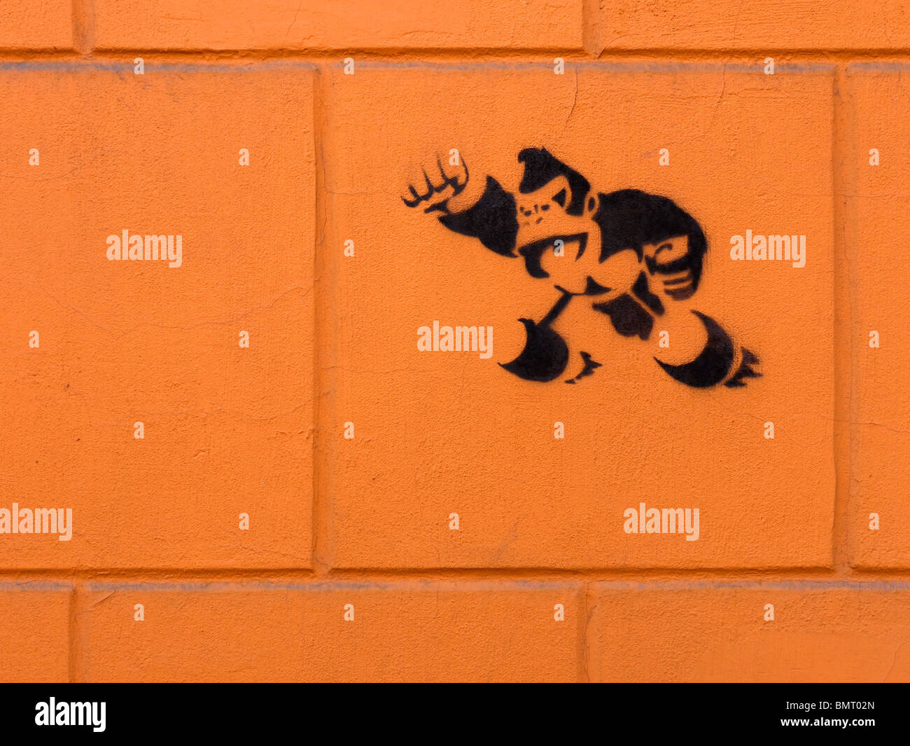 Funny stencil drawing on the orange wall in Izhevsk, Udmurt Republic, Russia Stock Photo