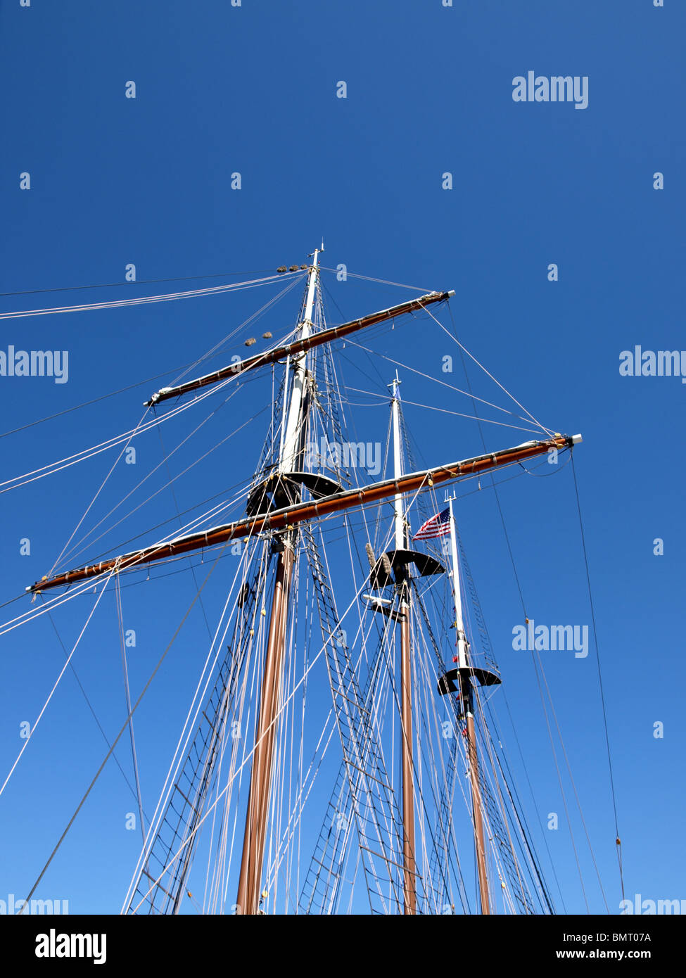 tall ship three masted masts ratings ladders flags blue sky sails Stock Photo Alamy