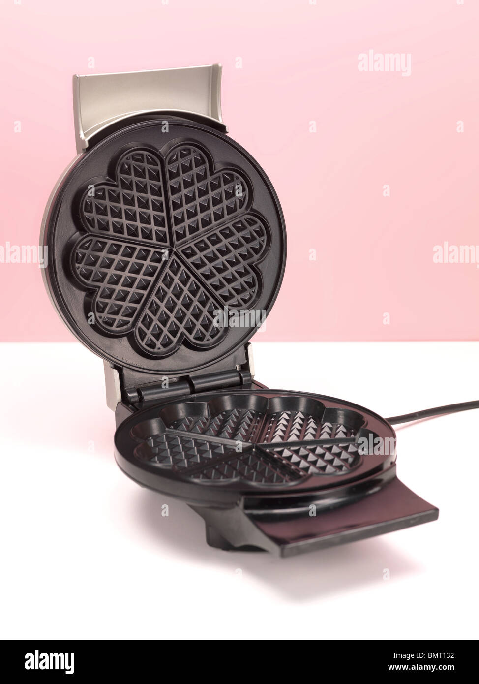 A waffle iron on a kitchen bench Stock Photo