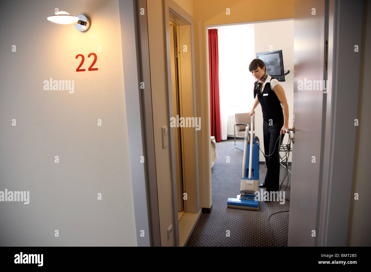 Hotel, room service, house keeping at work in a hotel room. Cleaning up