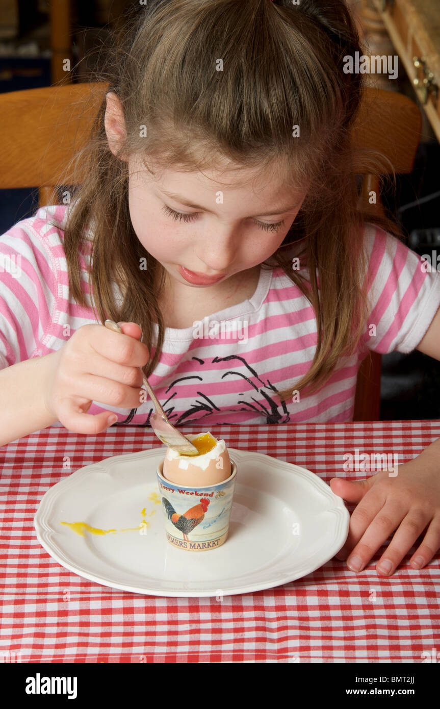 Young girl eating soft boiled egg for breakfast Stock Photo Alamy