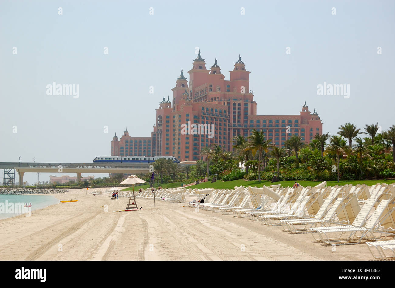 The beach of Atlantis the Palm hotel with a view on hotel and monorail train is  located on man-made island Palm Jumeirah Stock Photo