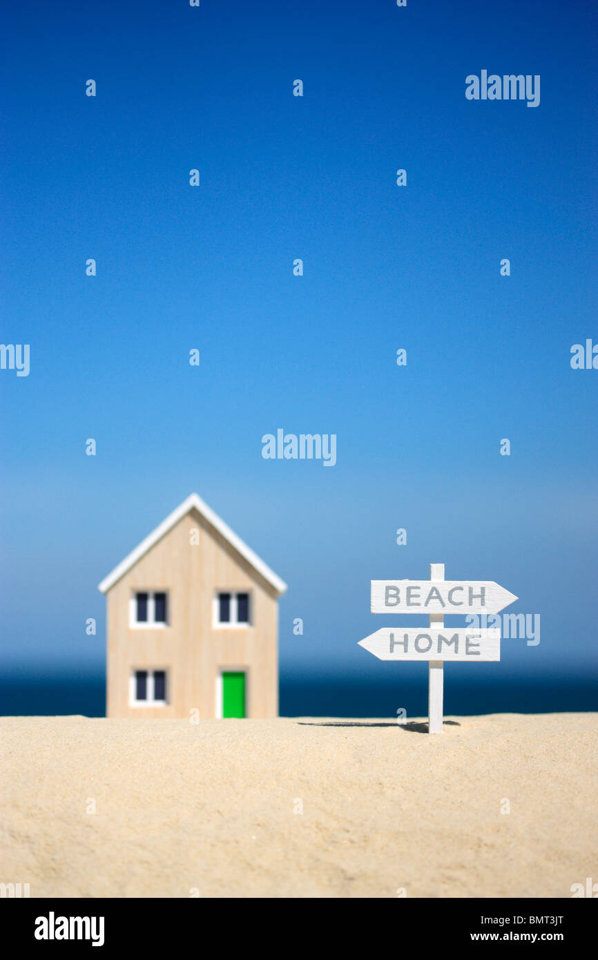 Model house and signpost Stock Photo