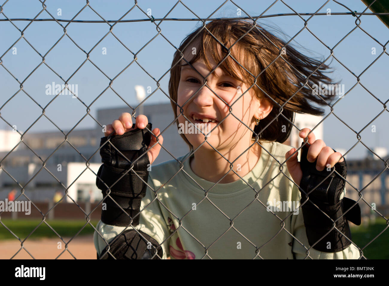 portrait of little girl and fence Stock Photo - Alamy
