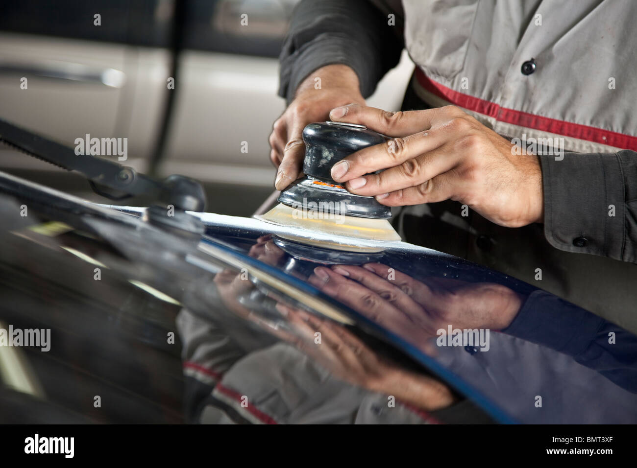 Auto repair using palm sander on car Stock Photo Alamy