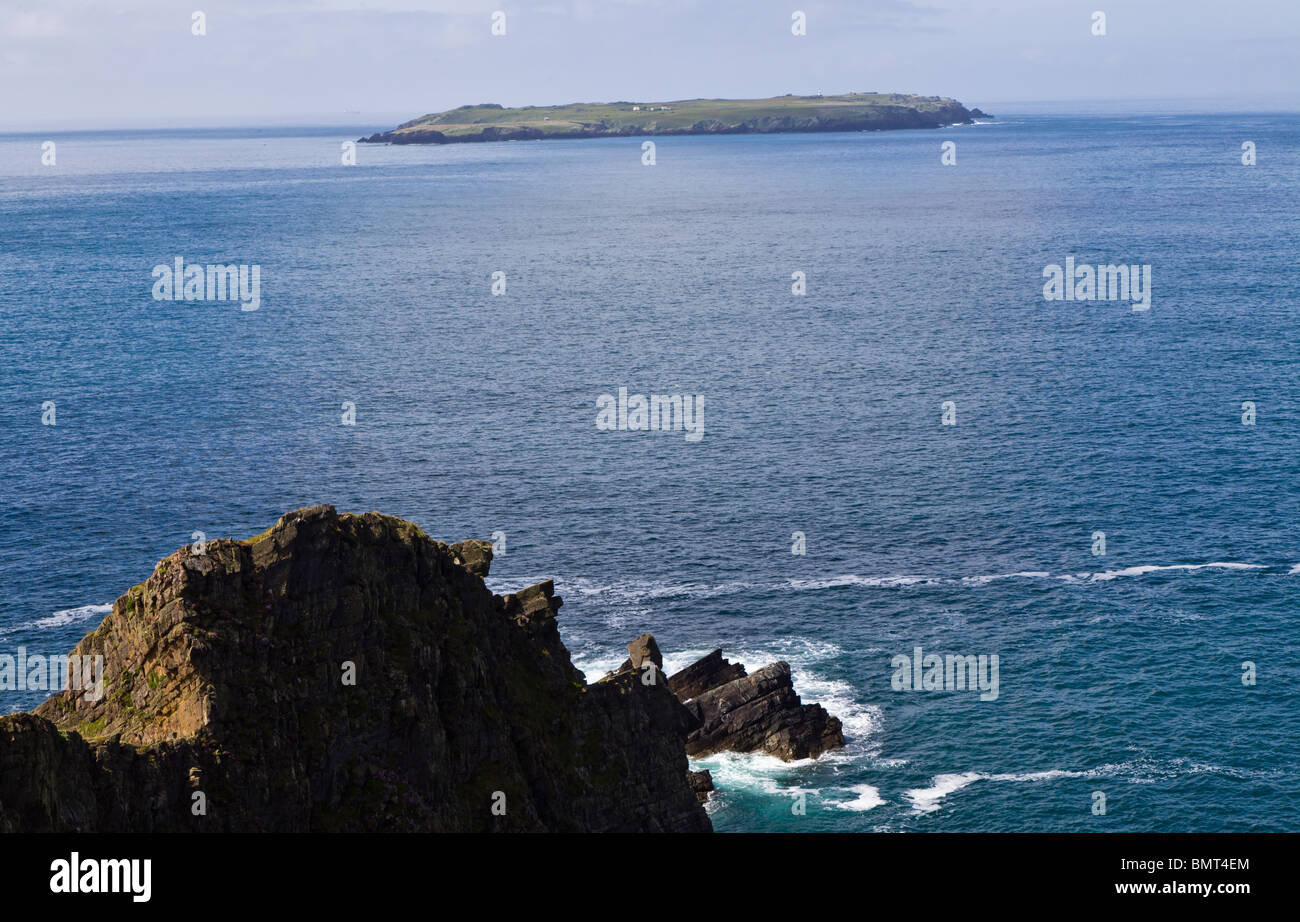 Rocks and cliffs on the Pembrokeshire coastal path looking out to Skokholm island Stock Photo
