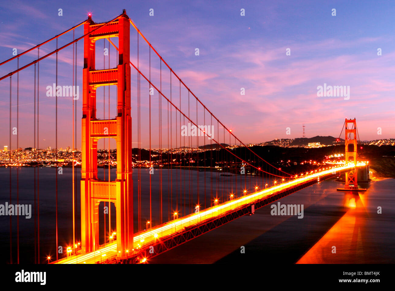 Golden Gate Bridge glowing at night Stock Photo - Alamy