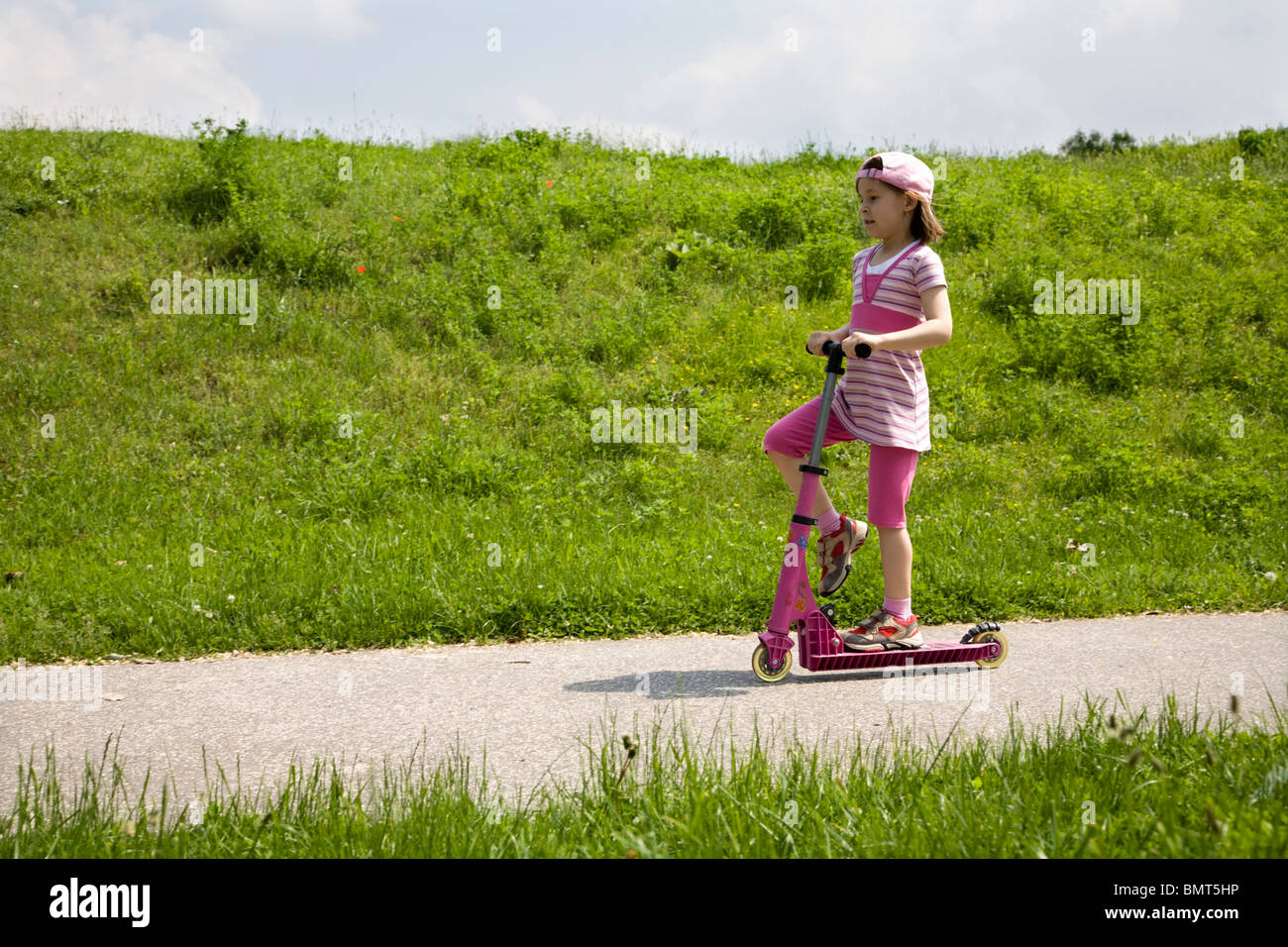 little girl on the scooter Stock Photo