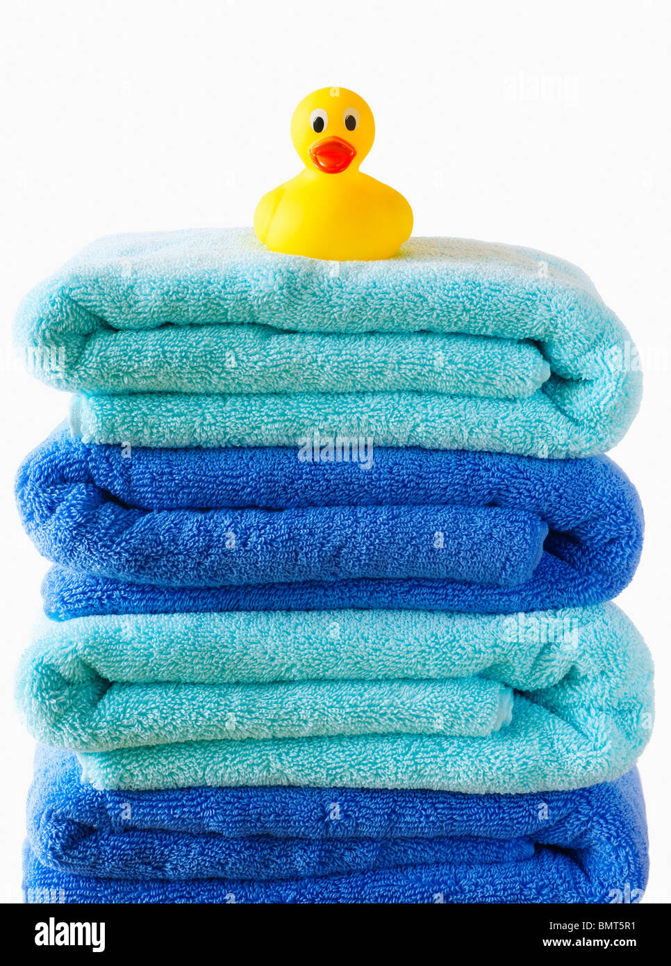 A Rubber Duck Sitting On A Pile Of Blue Bath Towels Stock Photo Alamy