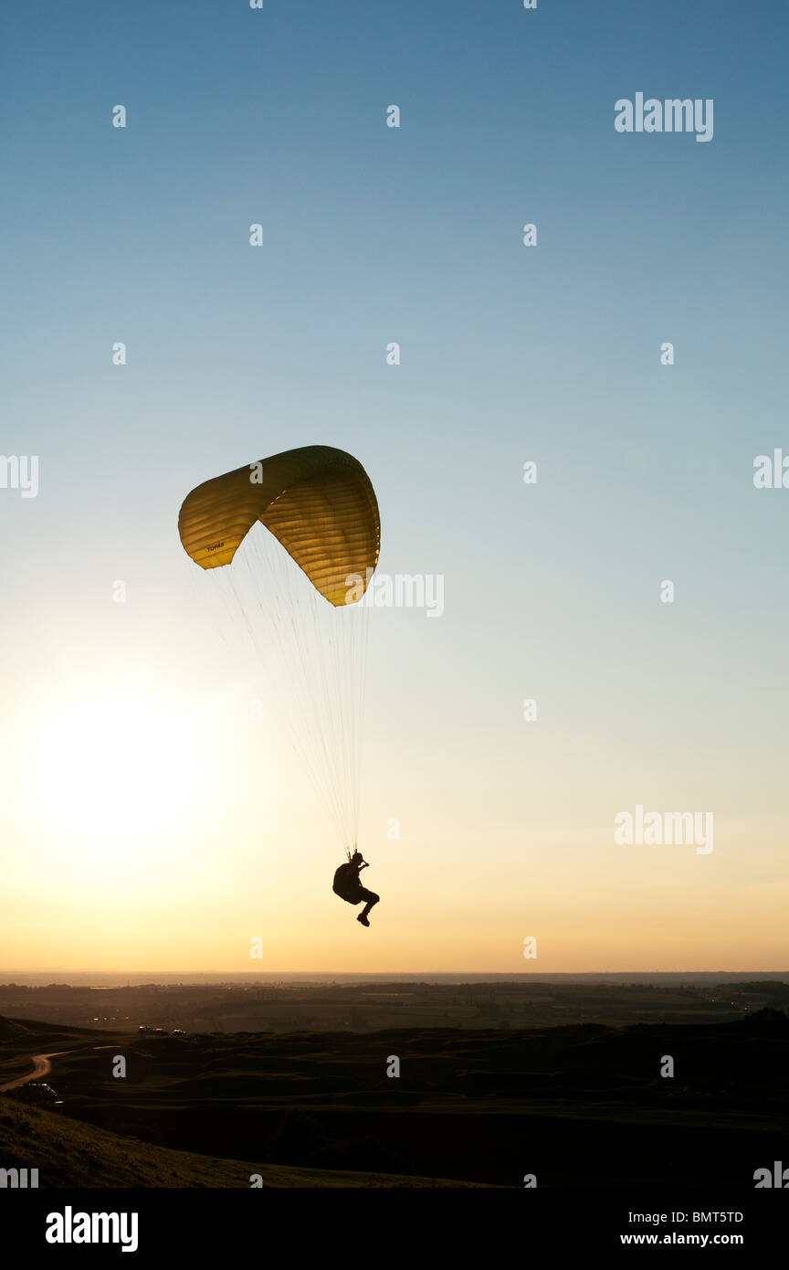 Paraglider silhouette at sunset in the English countryside Stock Photo
