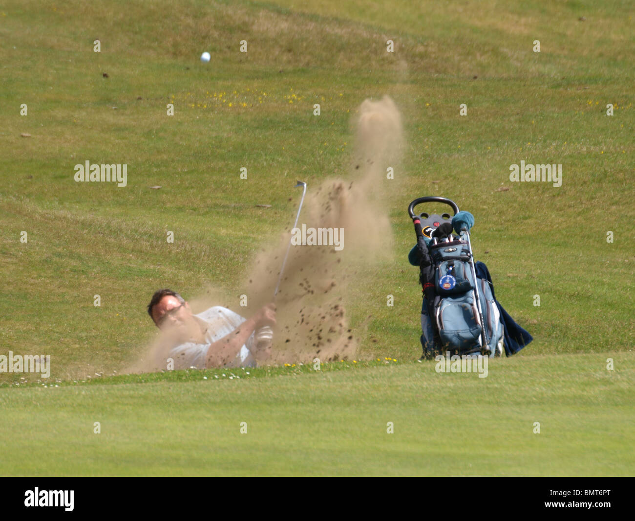 Bunker shot, golfer playing shot out of bunker, Royal North Devon golf club, Westward Ho!  UK Stock Photo