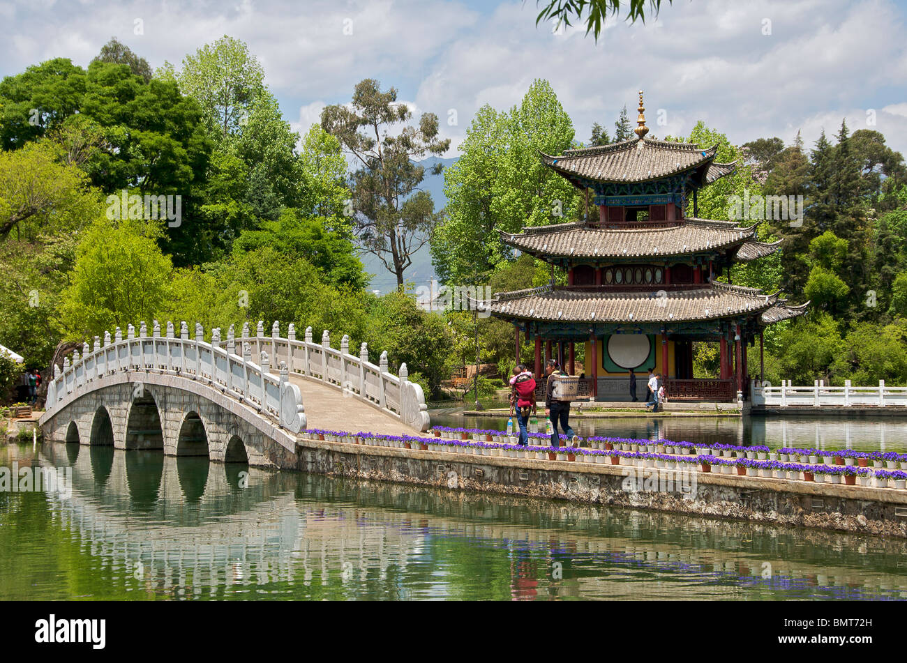 Moon Embracing Pavilion and bridge Black Dragon Pool Park Lijiang Yunnan China Stock Photo