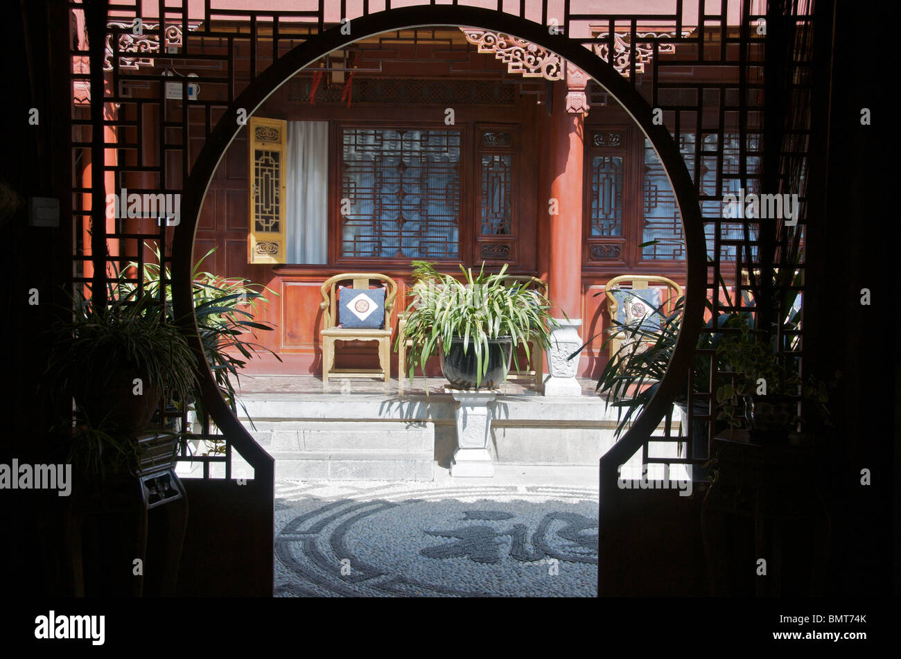 House front through round entrance Lijiang Old Town Yunnan China Stock Photo
