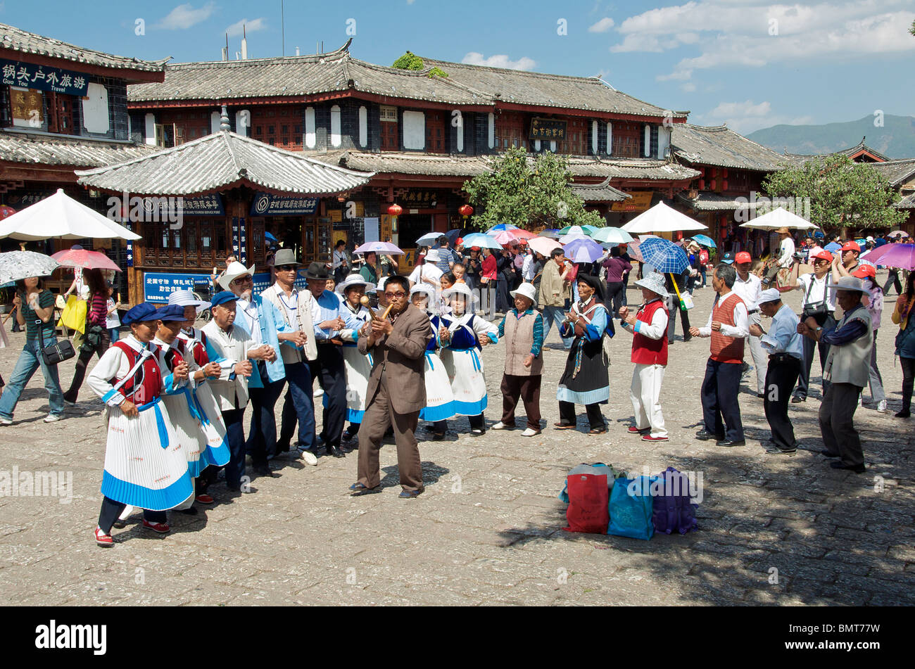 Naxi minority people dancing Sifong Square Lijiang Old Town Yunnan China Stock Photo