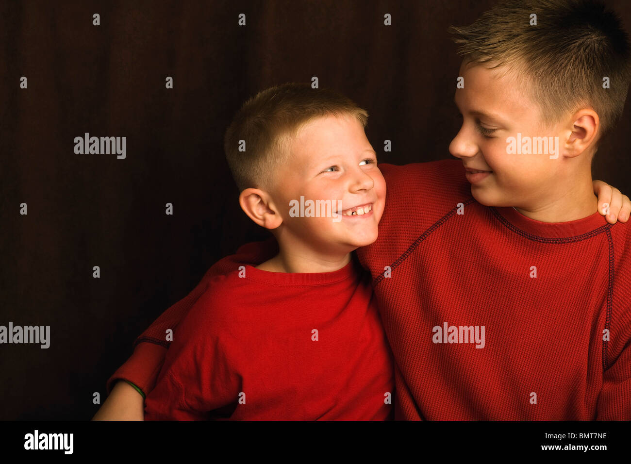 Two Brothers Wearing Red Shirts Stock Photo