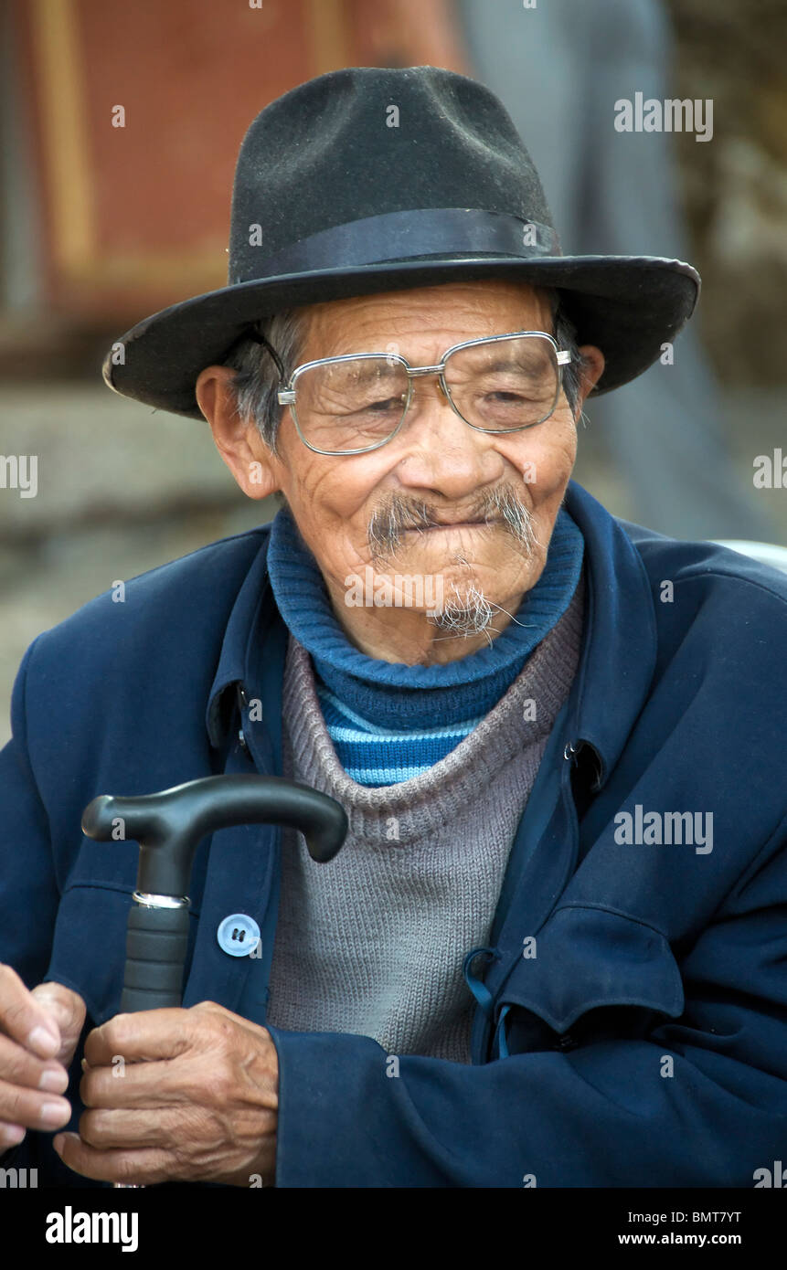 Portrait Naxi spectacled man Sifong Square Lijiang Old Town Yunnan China Stock Photo