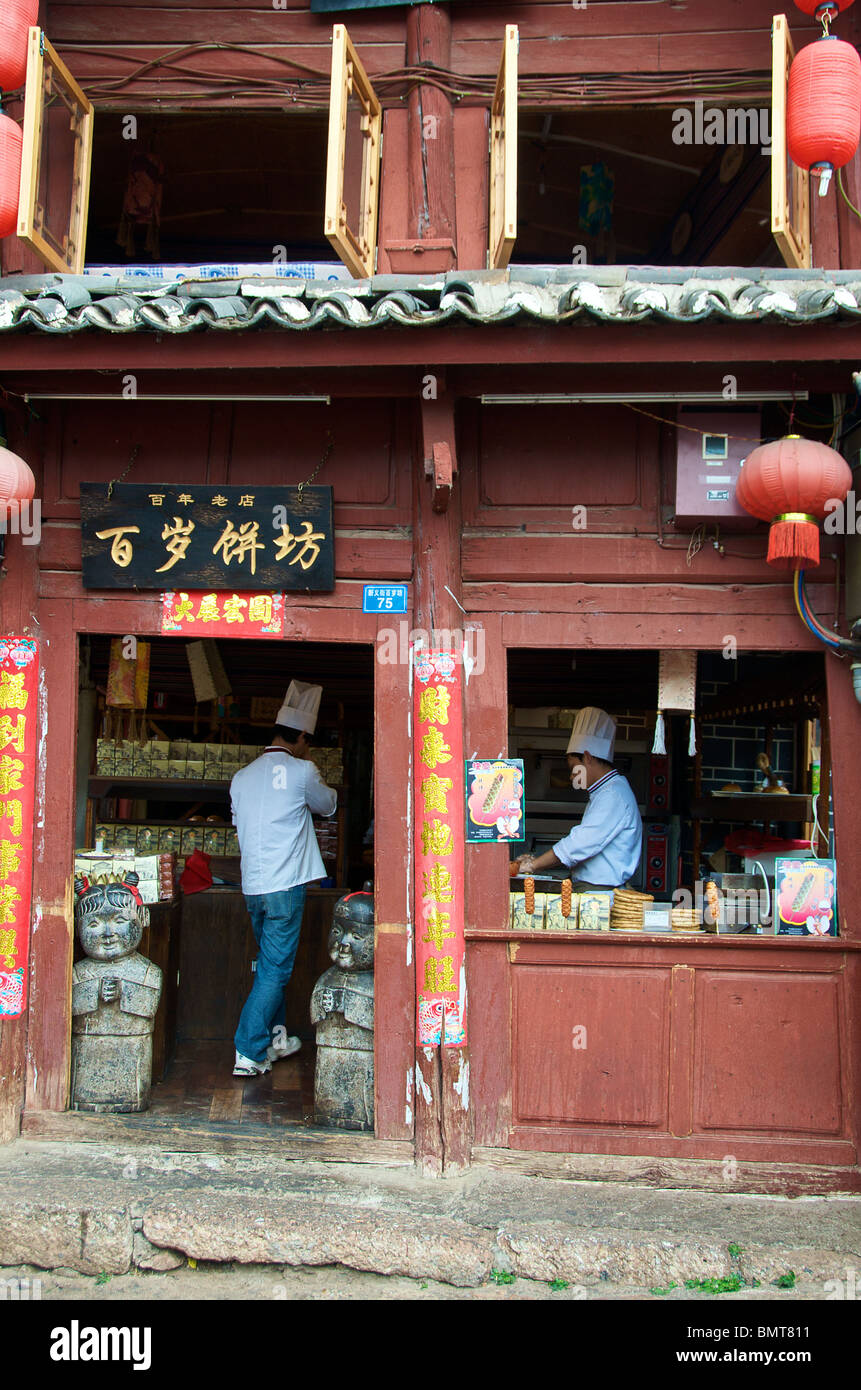 Two chefs preparing waffles Lijiang Old Town Yunnan China Stock Photo