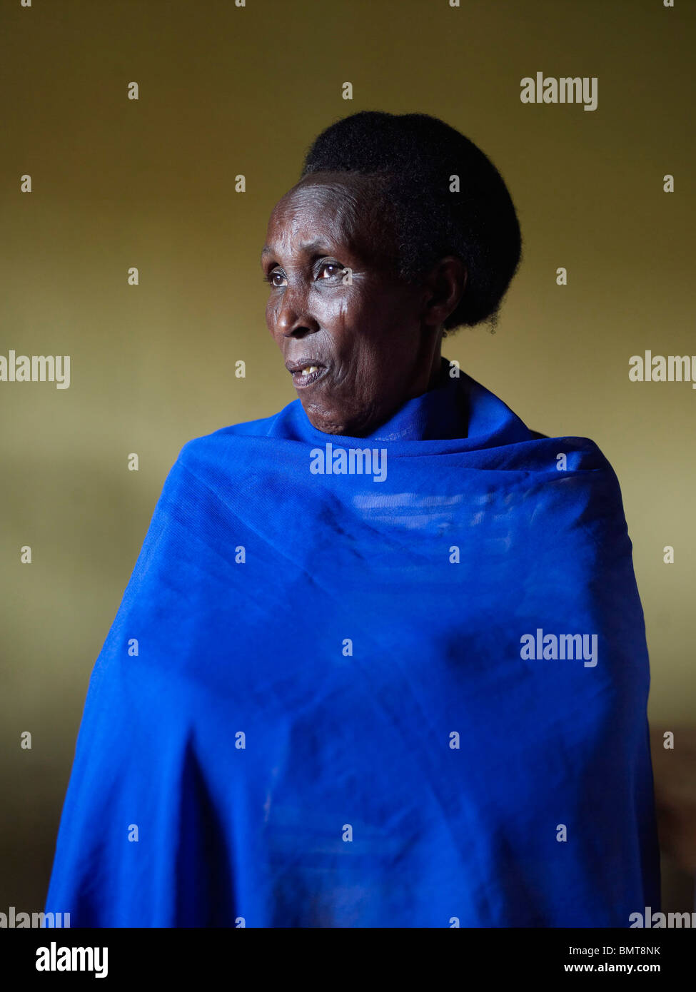 African lady wearing a blue blanket after the Rwandan genocide Stock Photo