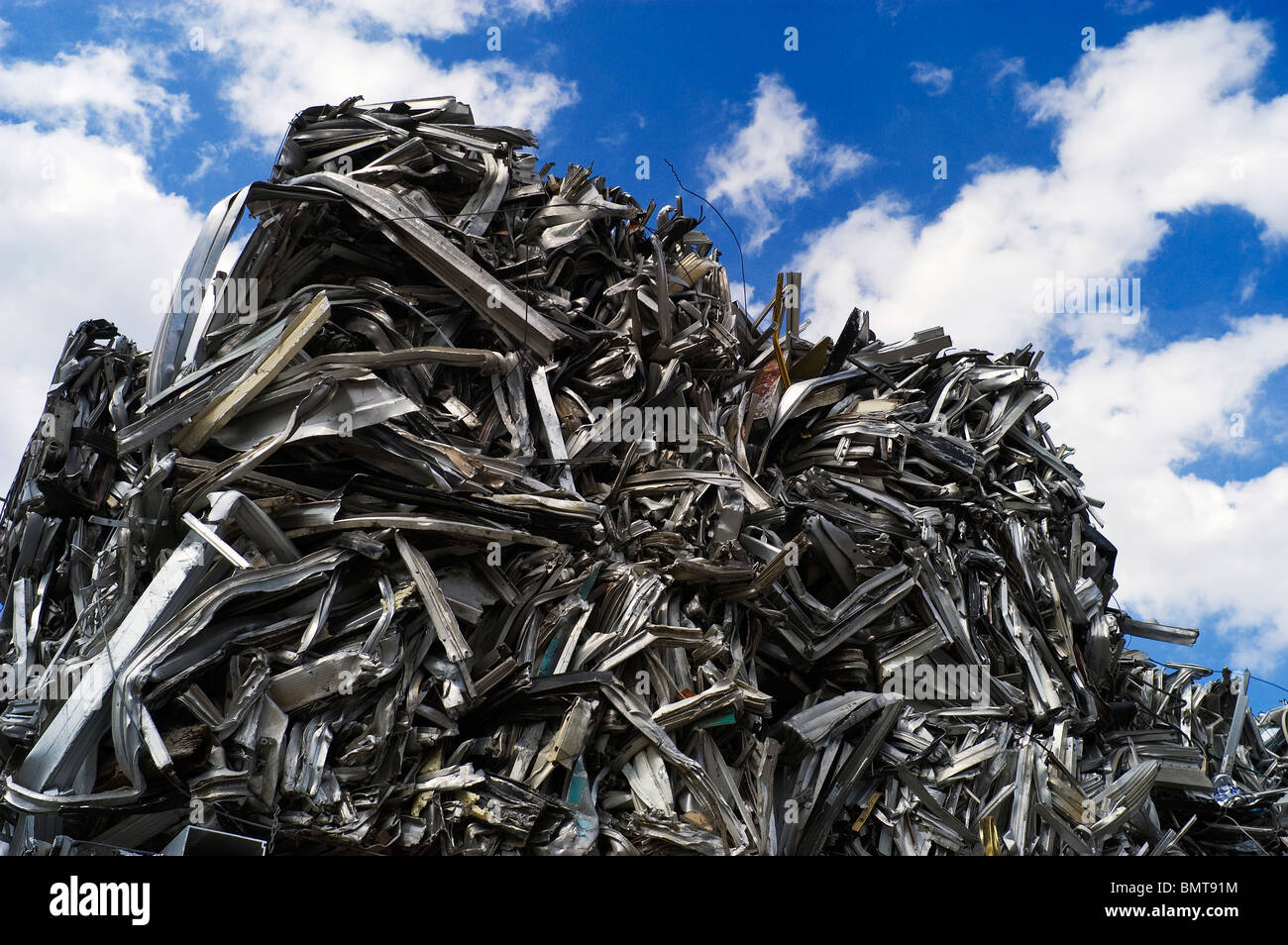 Scrap aluminum has been crushed, baled, and piled high with a clean
