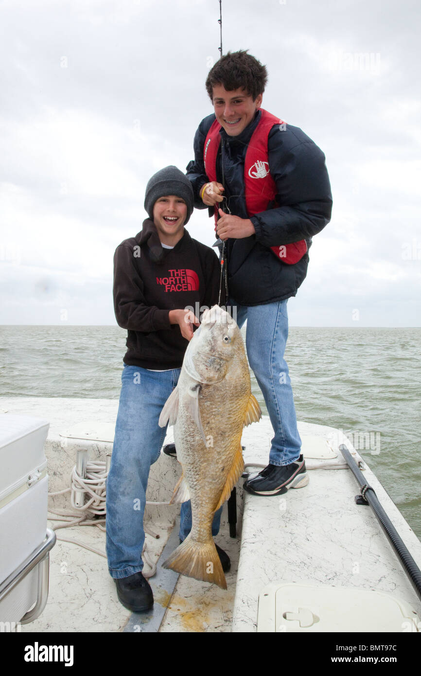 Teen brothers with black drum caught on live bait off Port Mansfield in the Lower Laguna Madre of the Texas Gulf Coast, USA Stock Photo