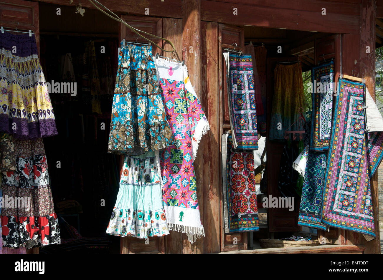 Clothes and textile shop front Lijiang Old Town Yunnan China Stock Photo