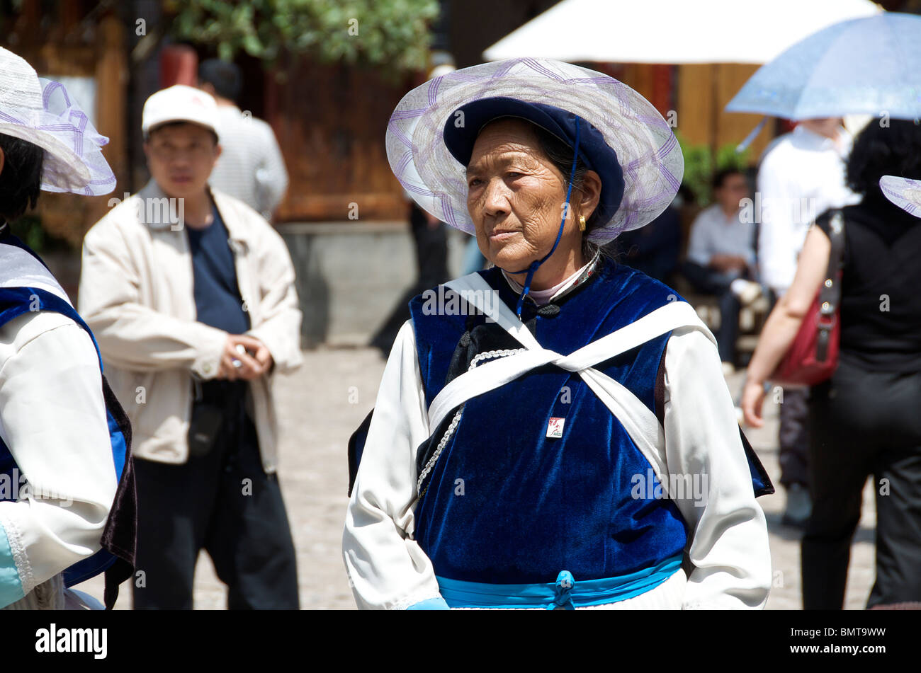 Naxi woman in costume dancing Sifong Square Lijiang Old Town Yunnan China Stock Photo