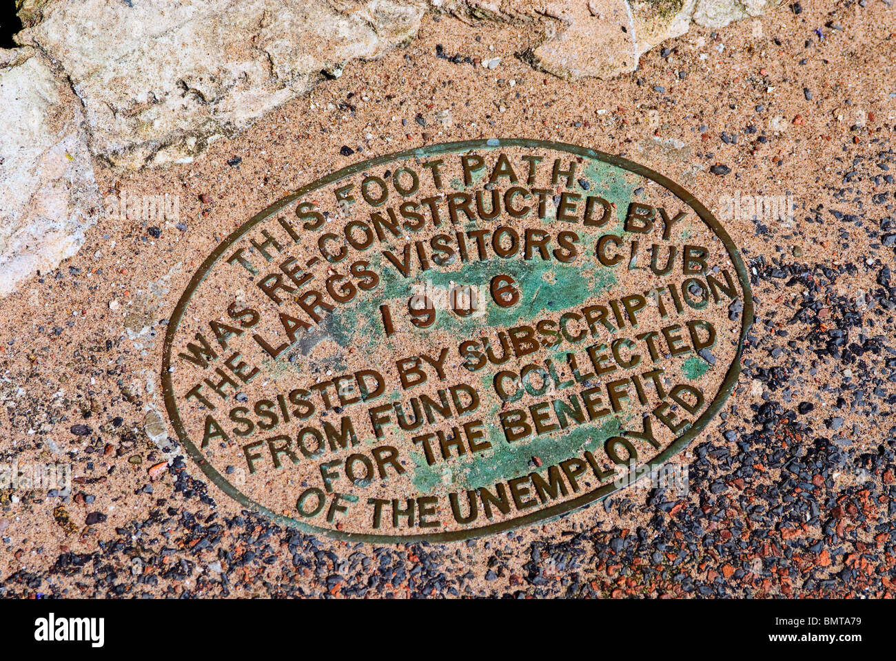 A brass plaque embedded in a coastal footpath in Largs, Scotland Stock Photo