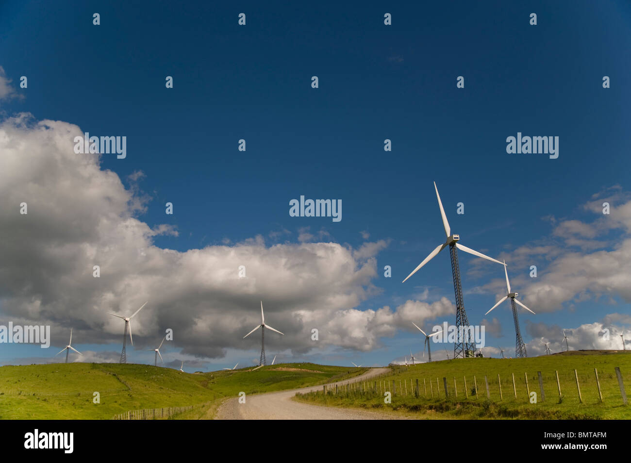Palmerston North, New Zealand; Wind Turbines In A Field With A Road Going Through Stock Photo