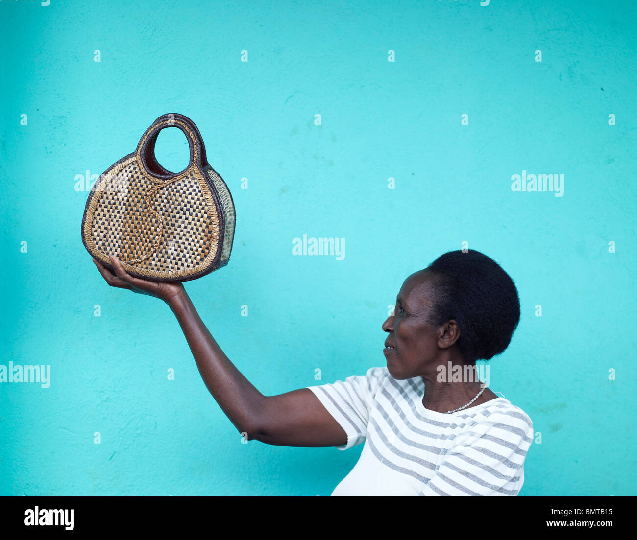 African lady holding a weaved bag in her hand in Rwanda, post genocide Stock Photo
