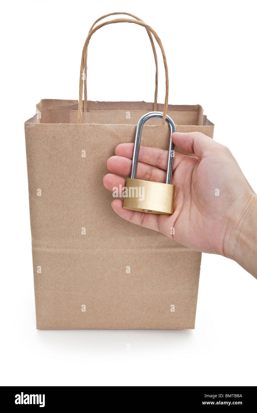 Brown paper shopping bag and lock, concept of tighten tudget Stock Photo