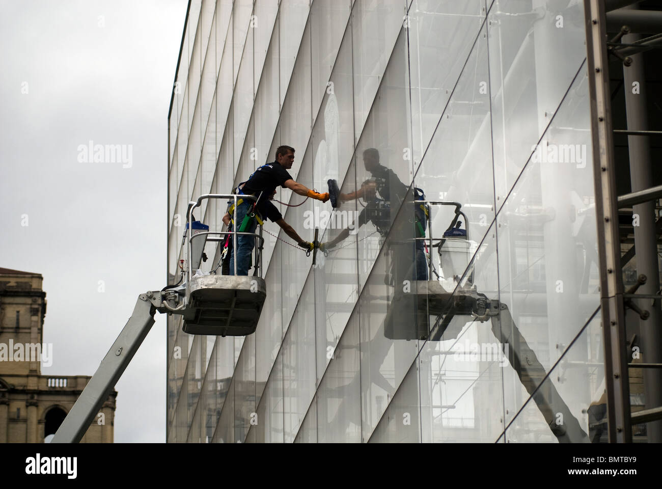 Window washers clean the massive glass curtain wall at the Rose Center