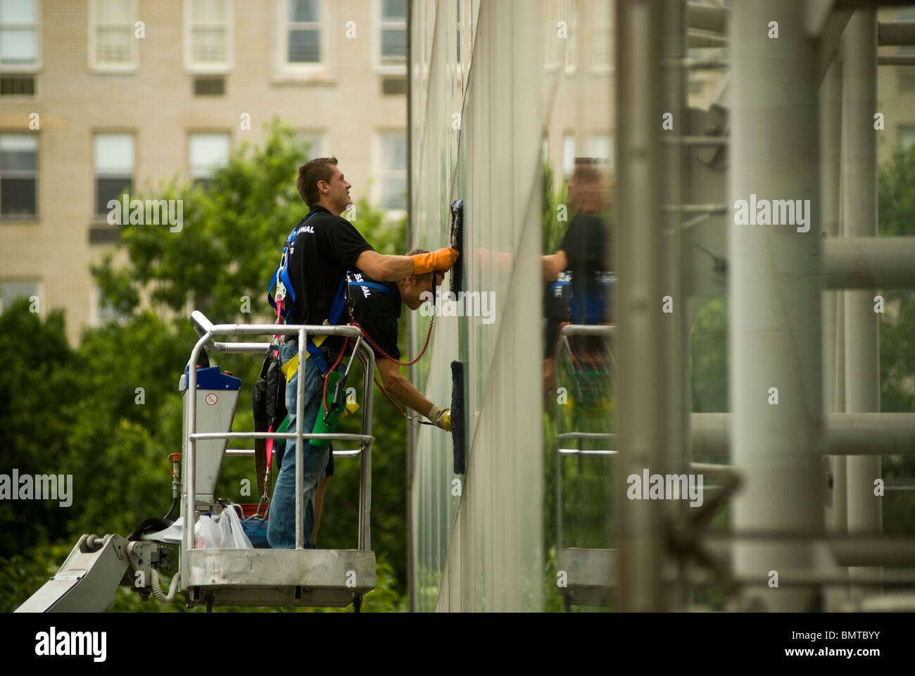 Window washers clean the massive glass curtain wall at the Rose Center