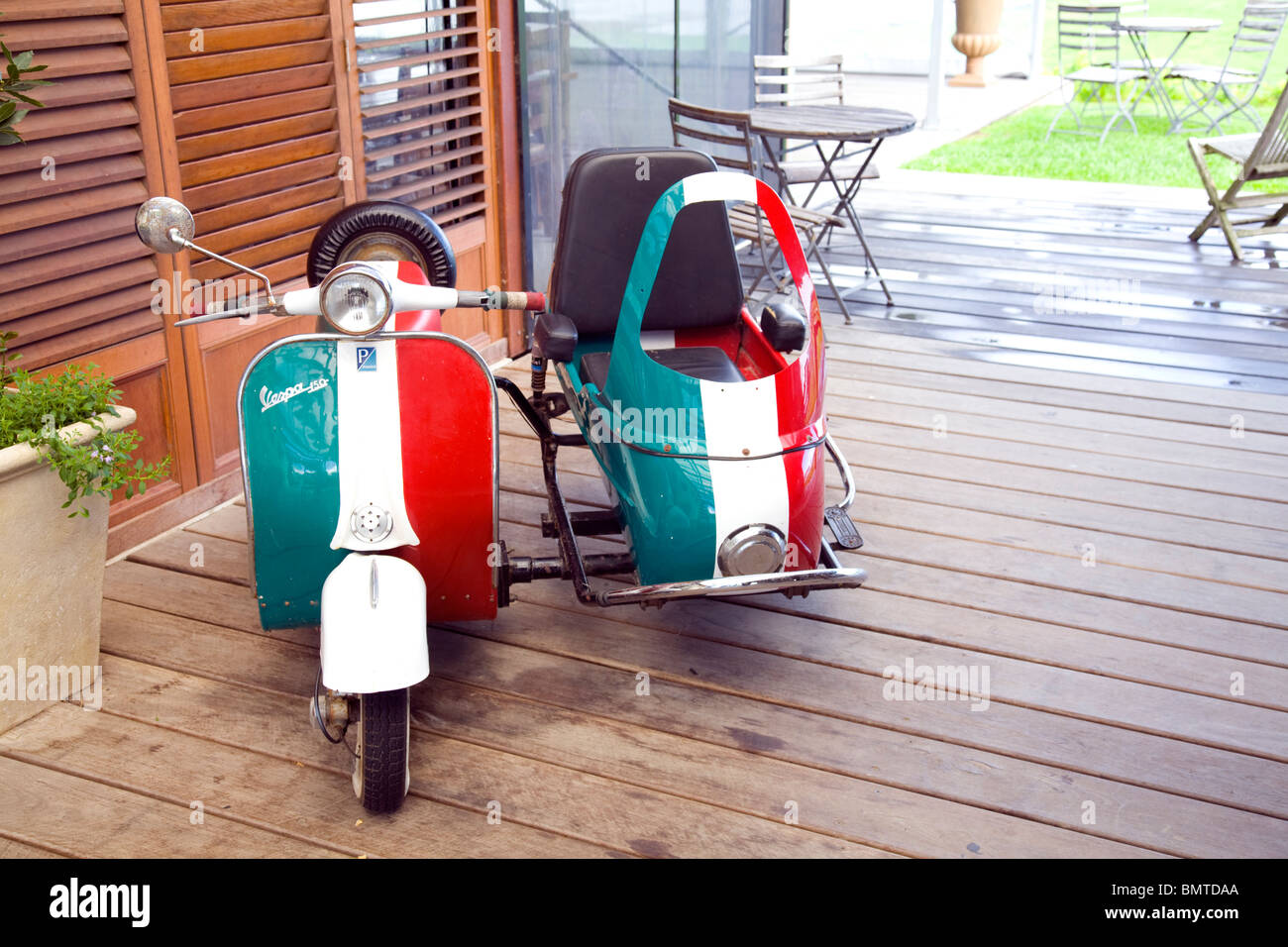 red white and green italian vintage vespa and sidecar Stock Photo
