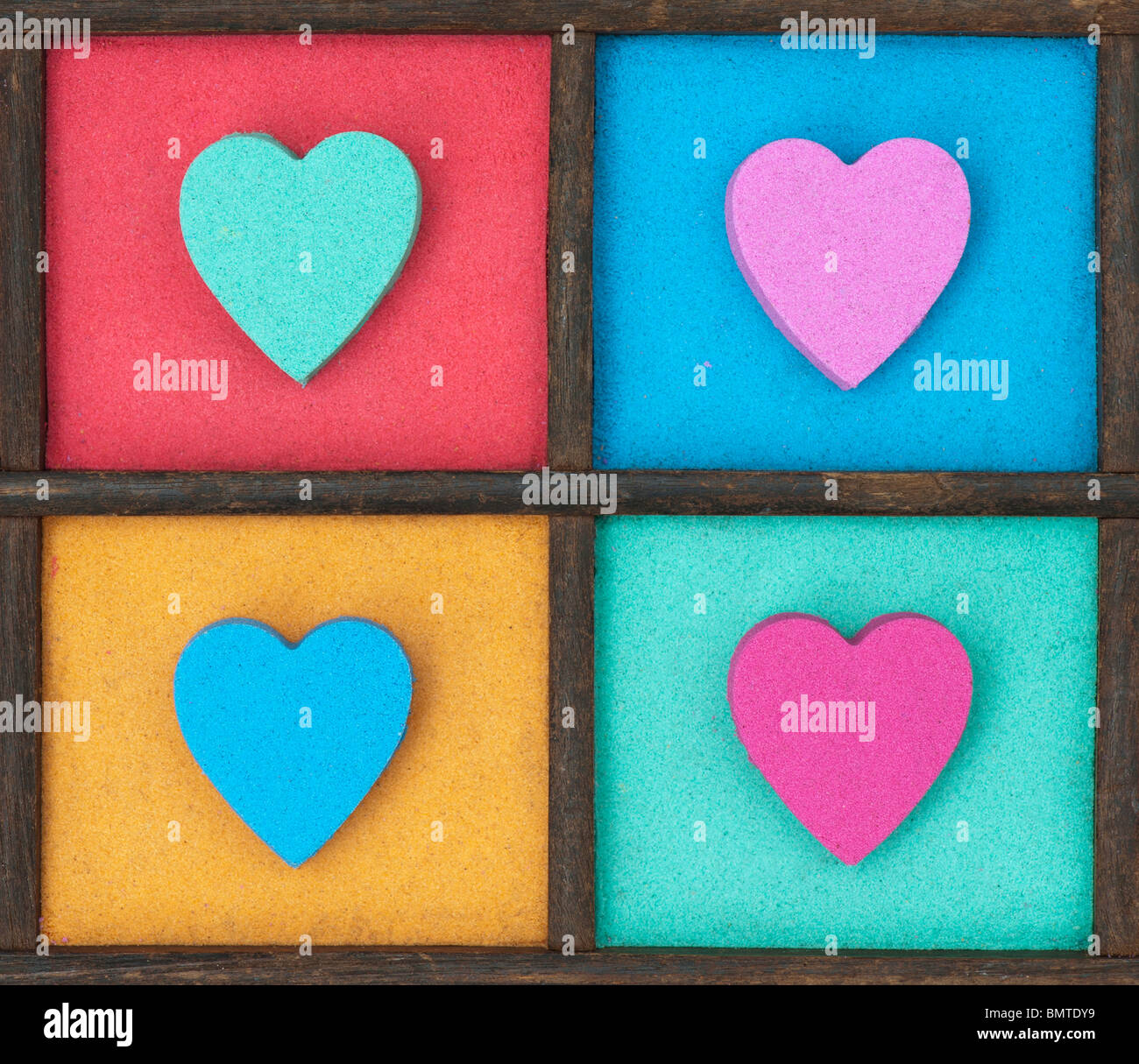 Multicoloured heart shape pattern in a wooden tray Stock Photo