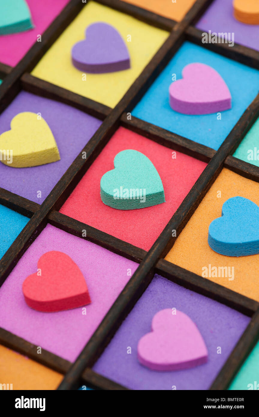 Multicoloured heart shape pattern in a wooden tray Stock Photo