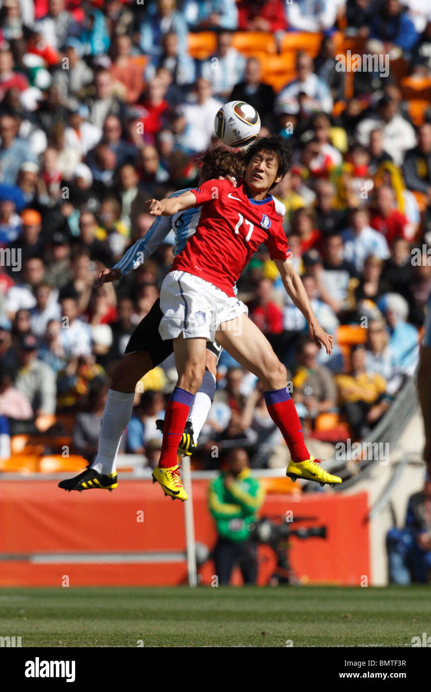 Chung Yong Lee of South Korea goes high for a header against Argentina during a 2010 FIFA World Cup football match June 17, 2010 Stock Photo