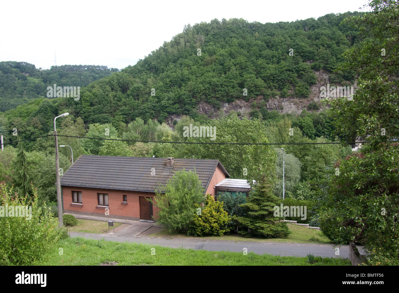 hillside village house steep road forest mountain Stock Photo - Alamy