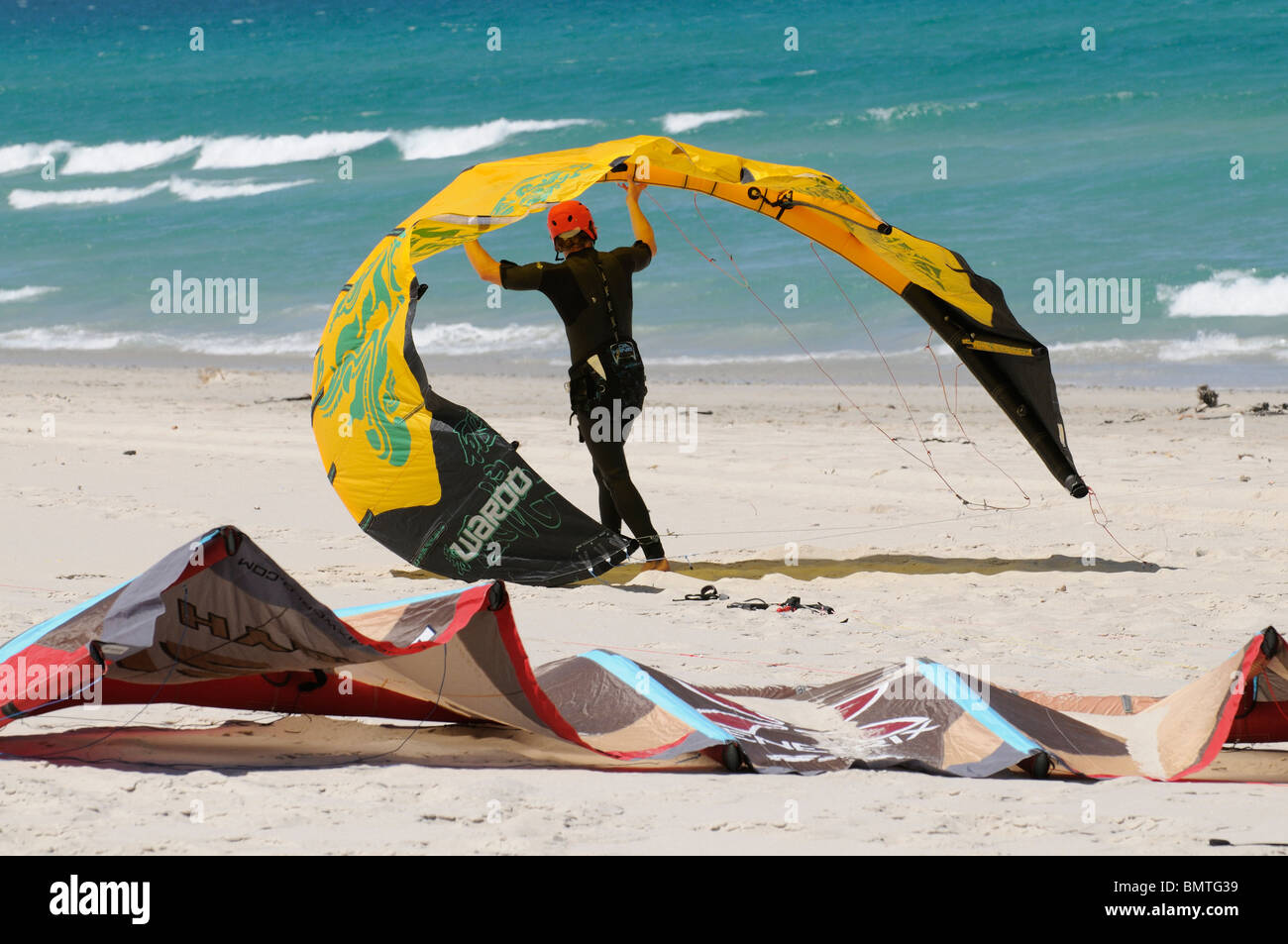 Kiteboarders prepare to ride their kites from Sunrise Beach Cape Town