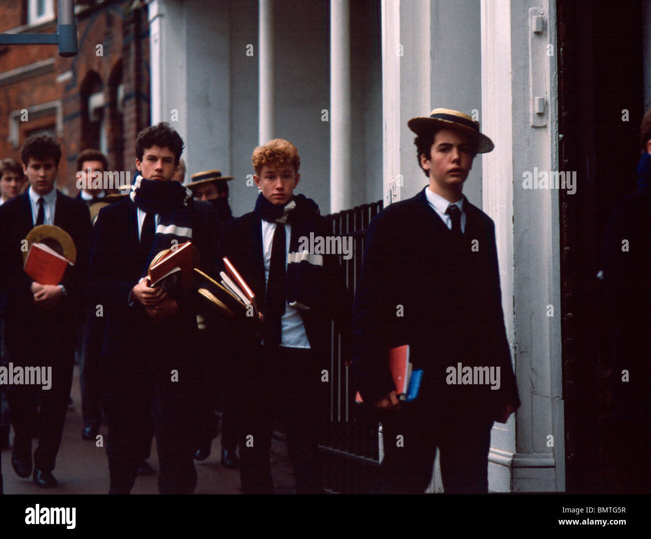 Harrow Schoolboys in their traditional straw hats and scarves, 1980's Stock  Photo - Alamy
