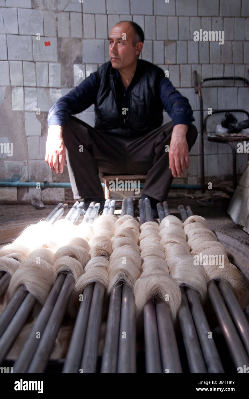 Local man at the Traditional silk factory in Margiland, Uzbekistan. Stock Photo